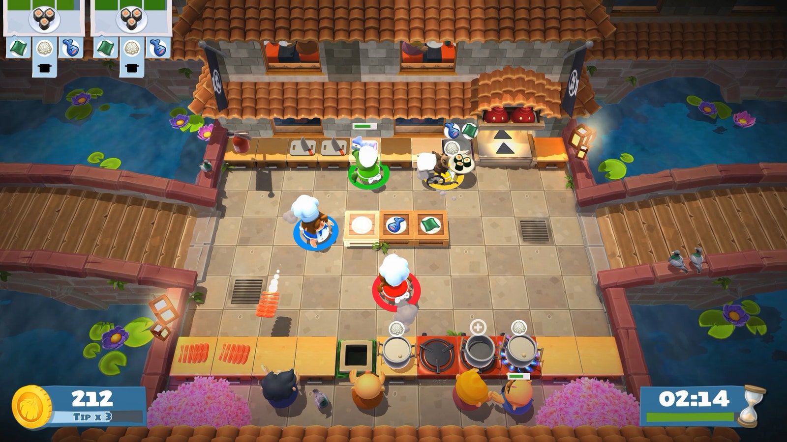 Captura de pantalla del videojuego 'Overcooked' con cocineros en una cocina haciendo comidas